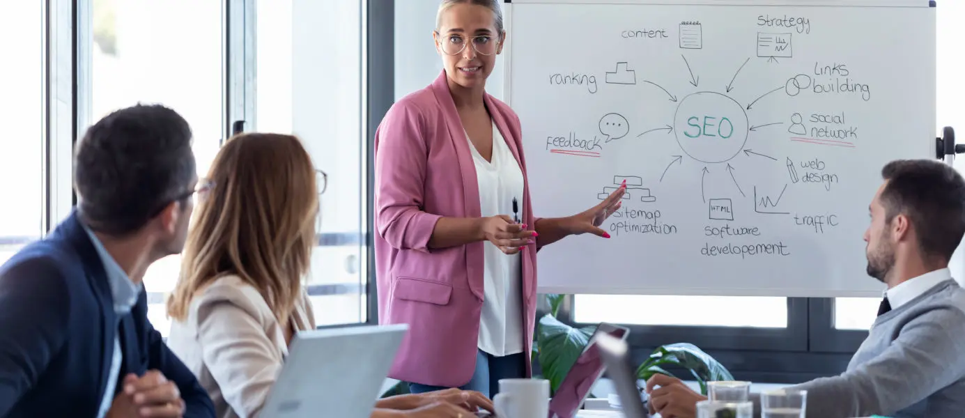 Femme d'affaires présentant une stratégie sur un tableau blanc